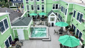 A rooftop pool area with multiple seating arrangements and a hot tub. - Murray Hotel (Mackinac Island)