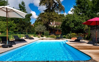 Seasonal outdoor pool, open 9:00 AM to 8:00 PM, pool umbrellas