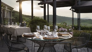 An outdoor dining area with tables set for a meal, overlooking a scenic landscape. - Altarocca Wine Resort Adults Only (Orvieto)
