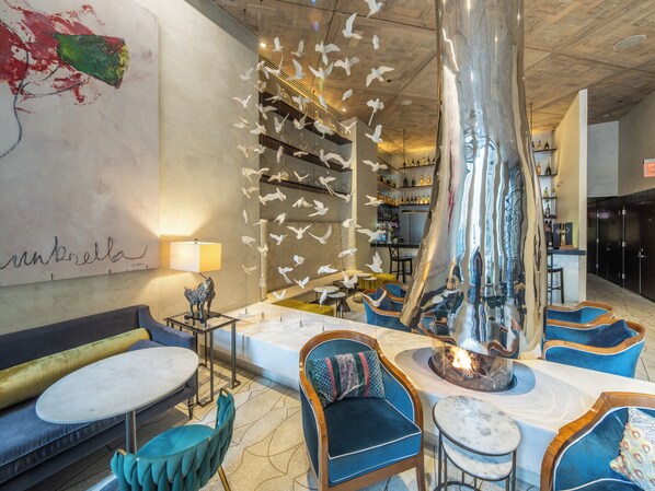 A modern interior with a bar area, seating, and a decorative sculpture. - The Marmara Park Avenue (New York)