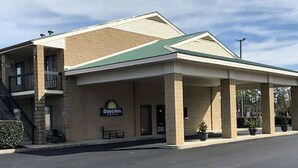 A Days Inn with a two-story structure, a covered front porch, and a signboard.