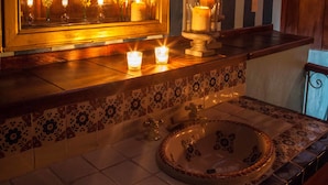 A bathroom with a large mirror, a sink, and candles on the counter. - Grand Guadalupe by Inmense (San Cristóbal de las Casas)