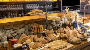 Un bufé con diversos alimentos y una selección de copas de vino.