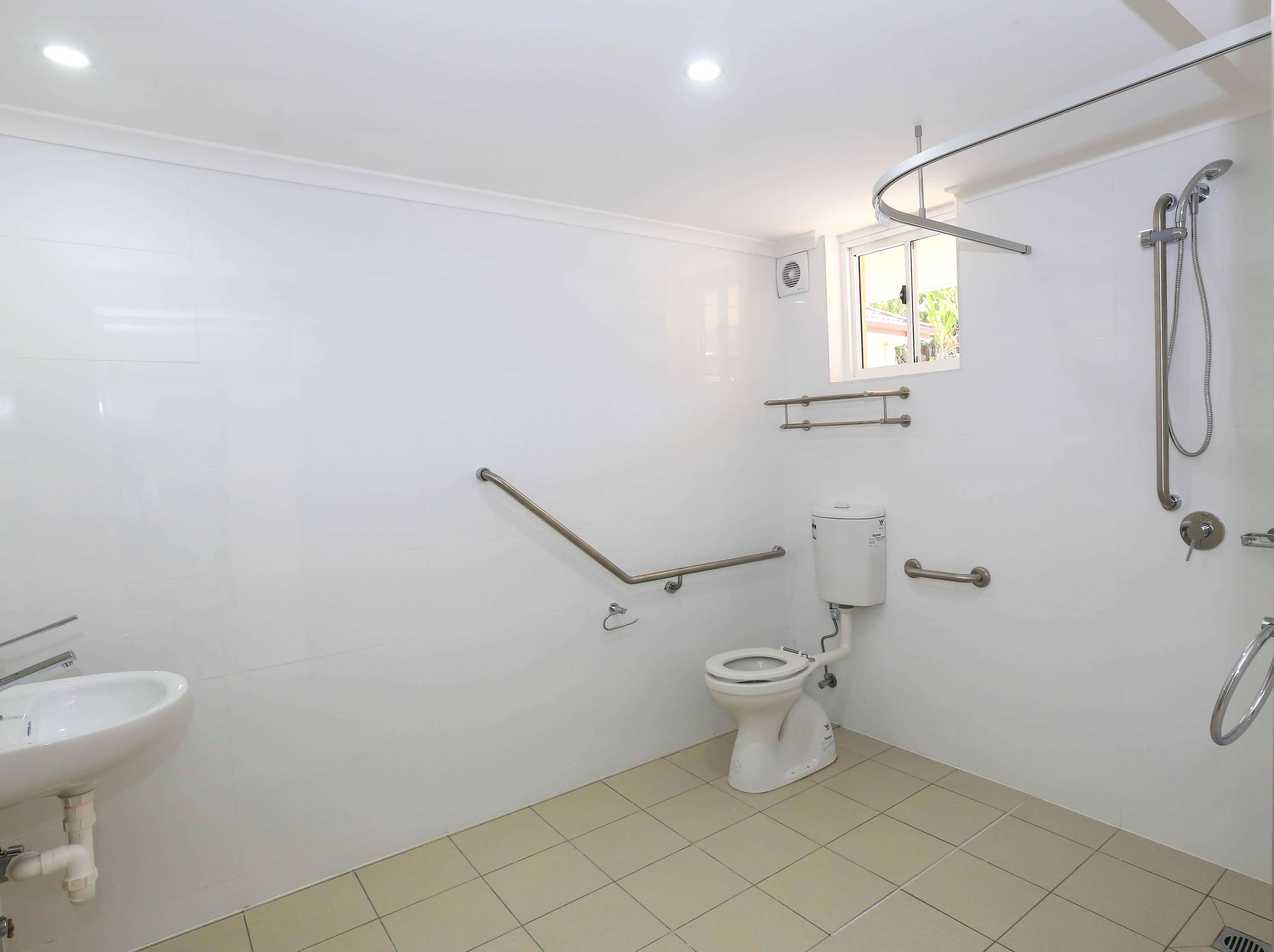 A bathroom with a toilet, a sink, and a shower.