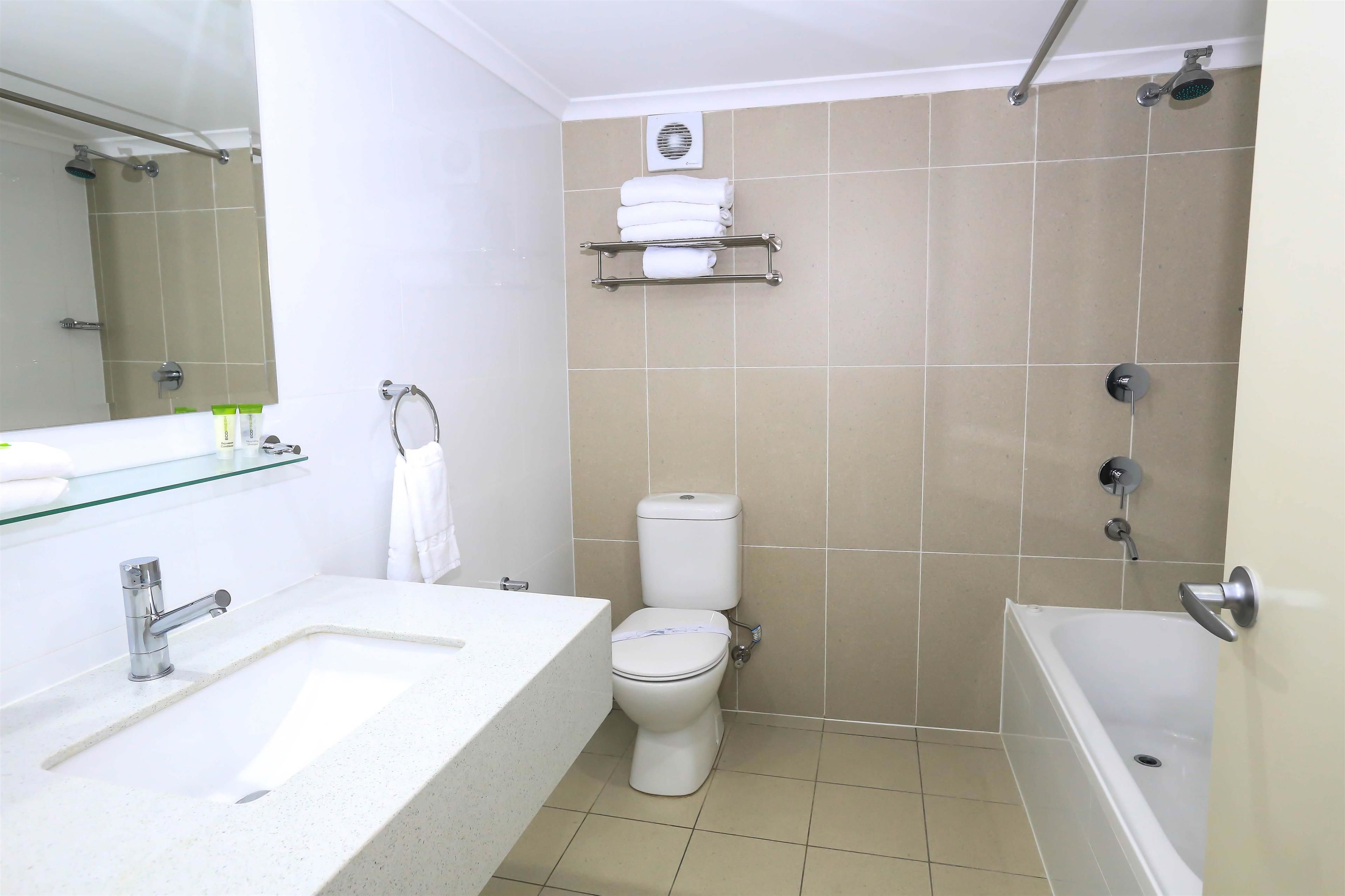 A bathroom with a sink, toilet, and bathtub.