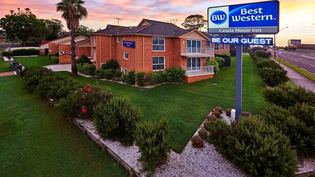 A Best Western hotel with a signboard, surrounded by well-maintained lawns and trees. - Best Western Casula Motor Inn (Casula)