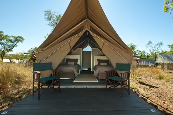 A tented accommodation with two bedrooms, each with a bed and a chair, and a central entrance. - Bungle Bungle Wilderness Lodge (Purnululu)