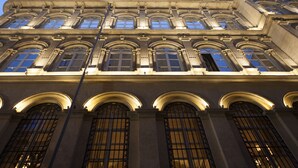 Un bâtiment à l’architecture classique, caractérisé par des fenêtres en arc et des moulures décoratives.