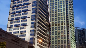 Two high-rise buildings with reflective glass facades and a clear sky.