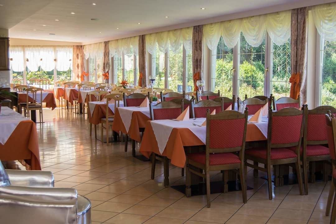A dining area with tables and chairs arranged for service.