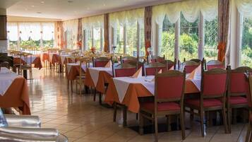 A dining area with tables and chairs arranged for service.