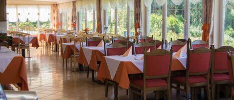 A dining area with tables and chairs arranged for service.