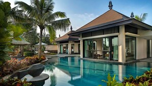 A modern resort with a swimming pool, palm trees, and a well-maintained garden. - Raffles Hainan (Lingshui)