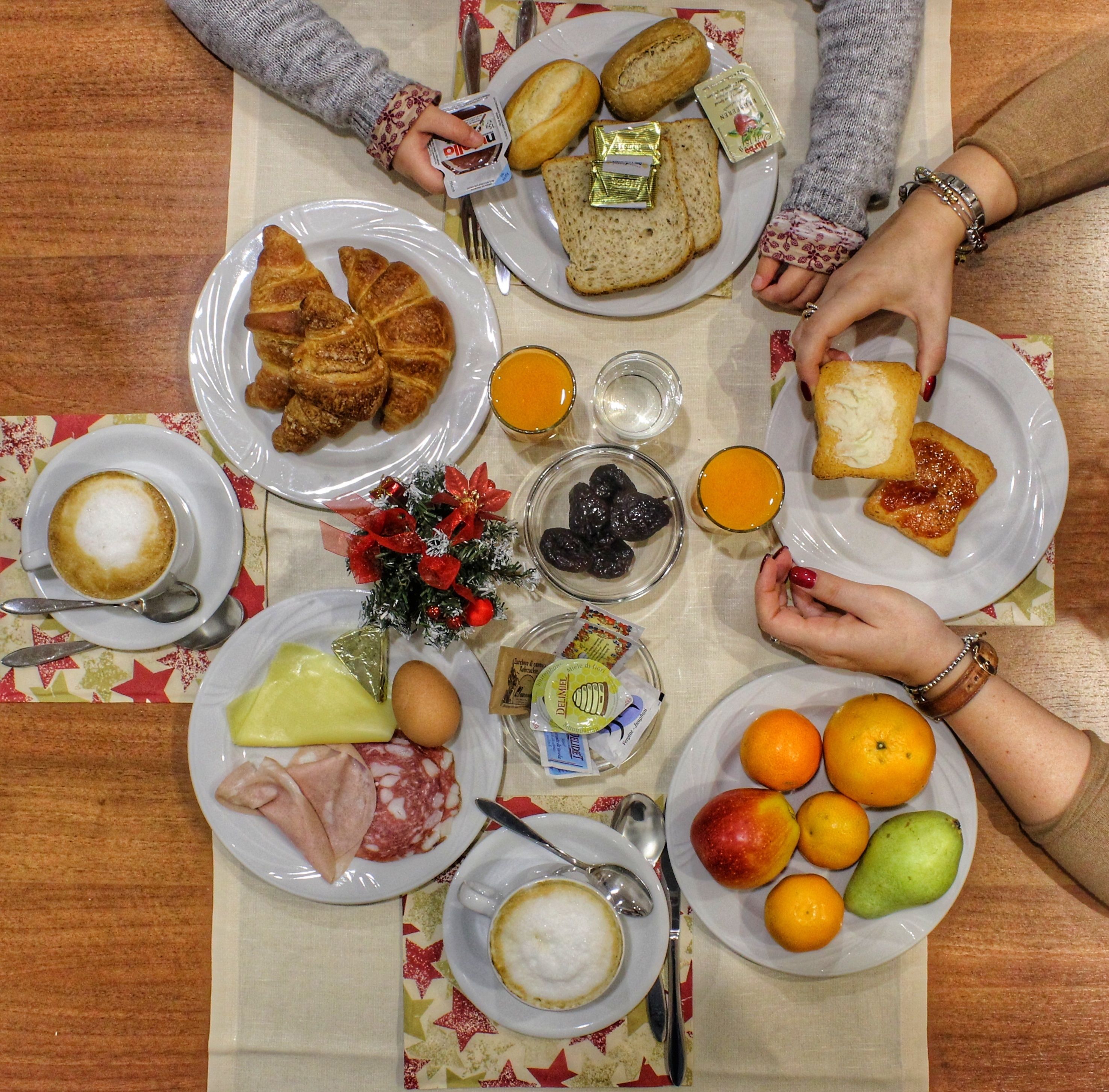 A table with various food items, plates, and a small Christmas decoration.