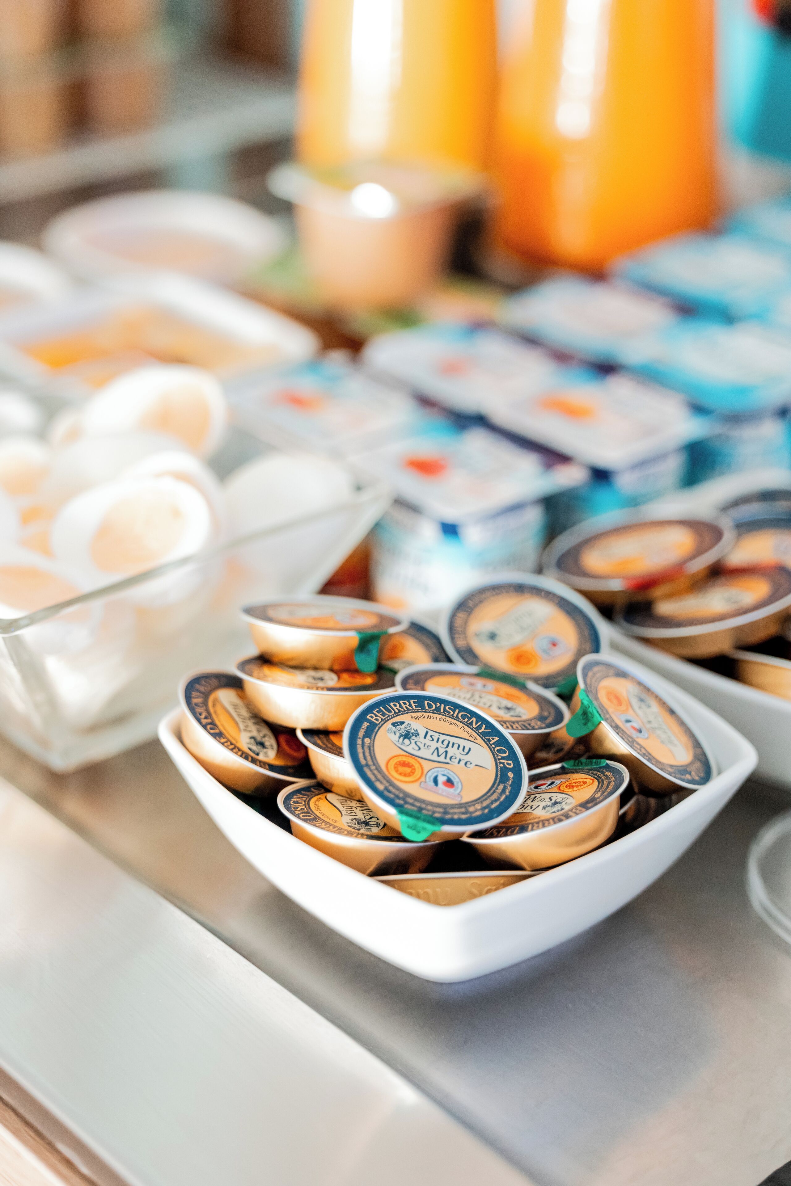 A buffet with various food items including yogurt cups and containers.