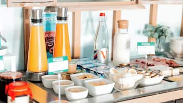 A breakfast buffet with various food items and beverages.