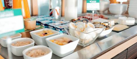 A buffet with various food items and containers.