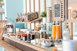 A breakfast buffet with various food items and condiments.