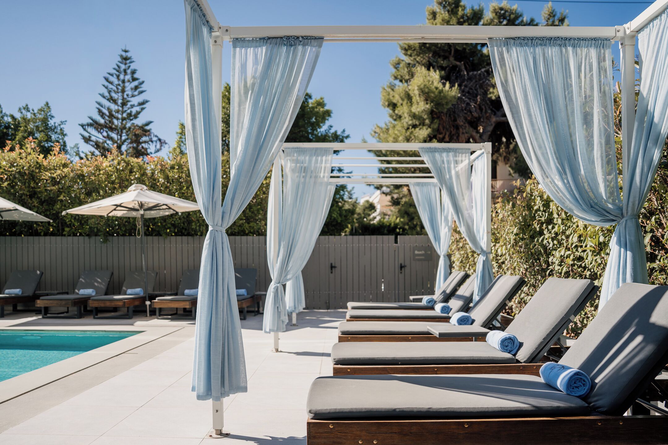 Seasonal outdoor pool, open 10:00 AM to 6:00 PM, pool umbrellas