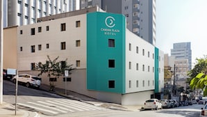 A modern hotel building with a teal and white facade, multiple windows, and a visible sign for 'Cardim Plaza Hotel'. - Hotel Cardim Plaza (São Paulo)