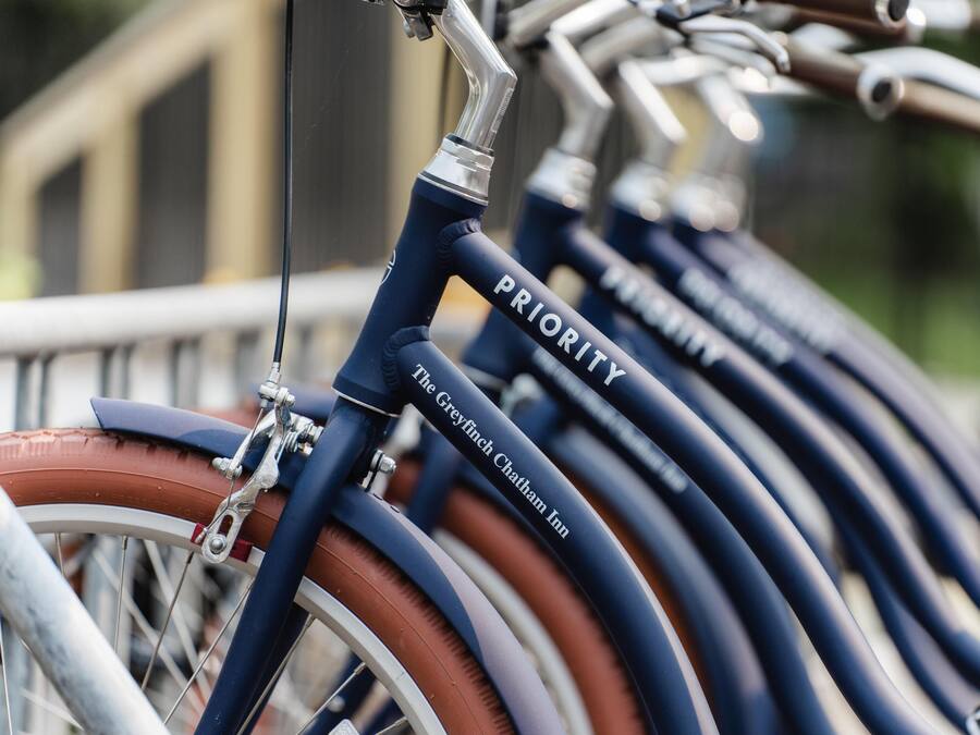 A row of bicycles with the word "PRIORITY" on the frame, indicating a bike-sharing program.
