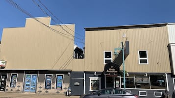 A building with a sign for '34 Fundy Restaurant' and a parked car in front.