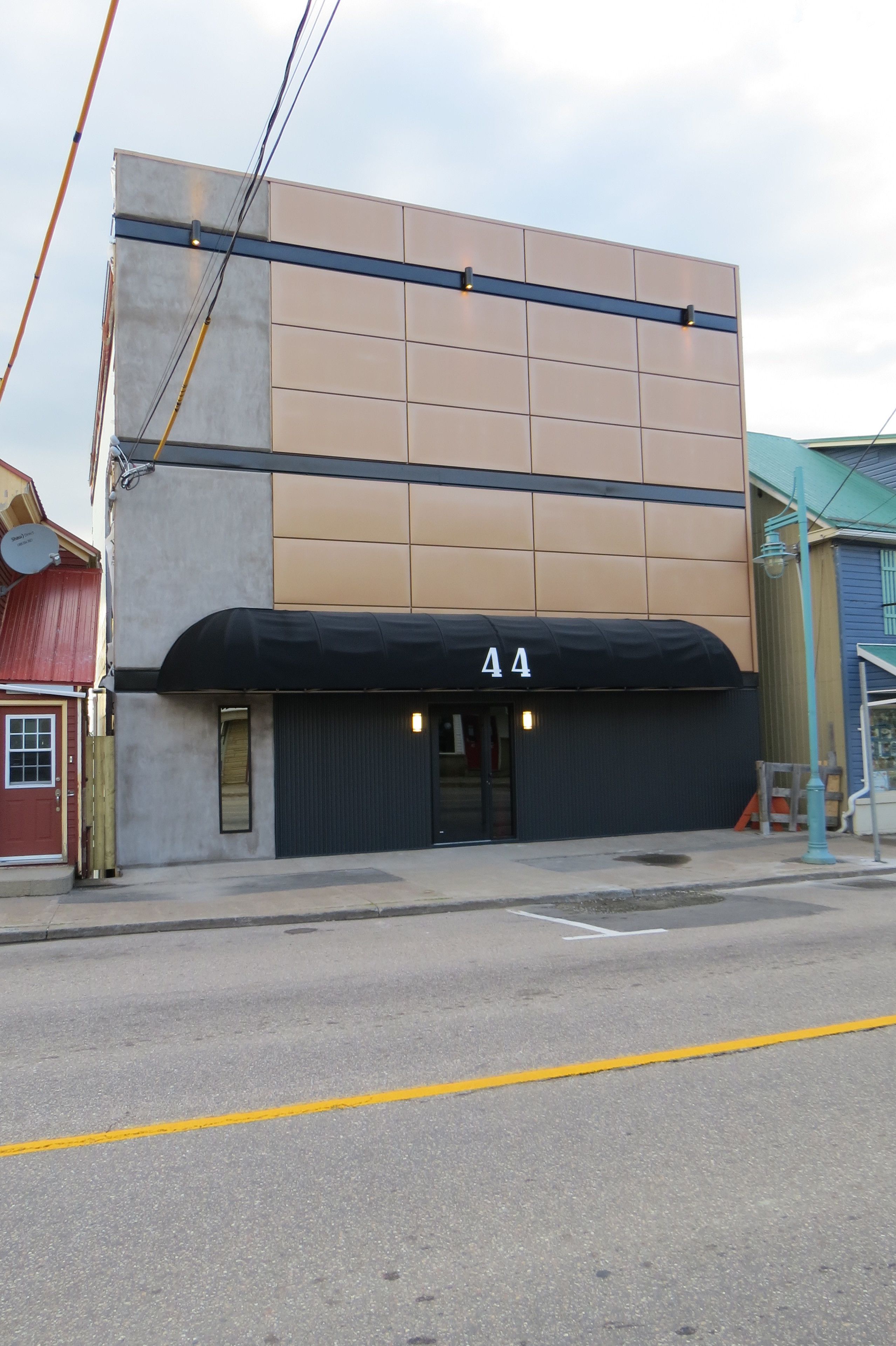 A building with a black awning and the number 44 on it.