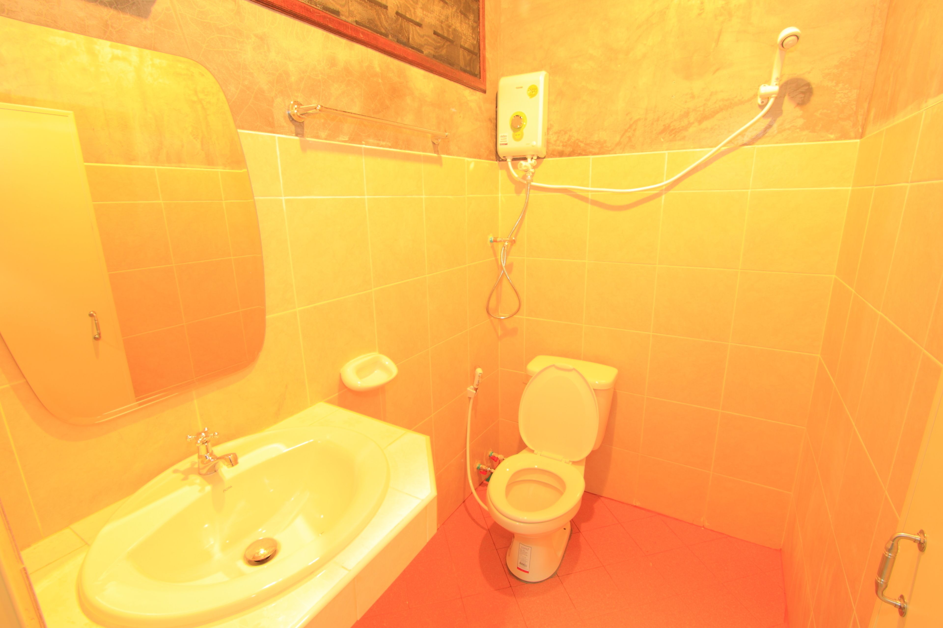 A bathroom with a sink, toilet, and shower.