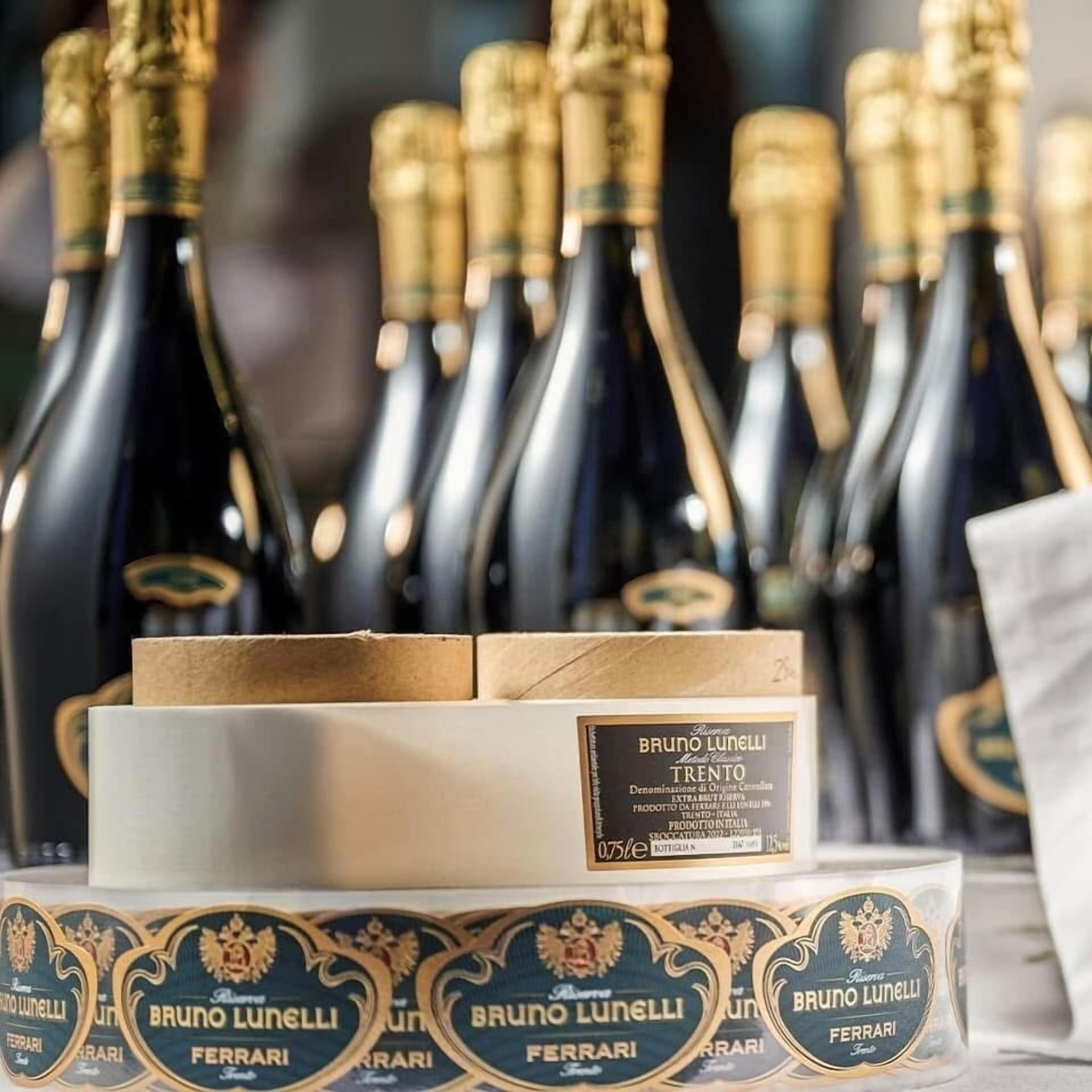 Multiple bottles of Brunolunelli Trento wine, a box of Brunolunelli Ferrari wine, and a label with the Brunolunelli logo.