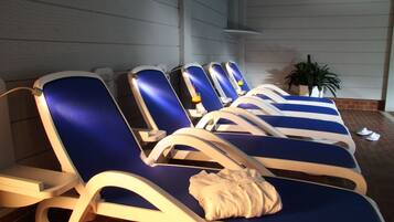 Relax in comfort with our lounge chairs, each featuring a cushion and armrest, set against a stylish backdrop.