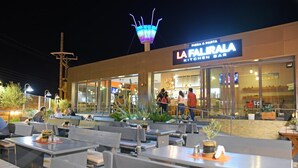An outdoor seating area with tables and chairs at La Falirala Kitchen Bar. - Falirala Central (Rhodes)