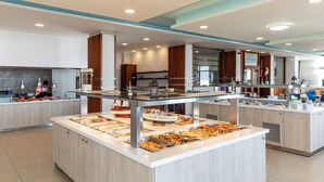 Un espace buffet moderne, doté de plusieurs postes de service et d’une cuisine située à l’arrière-plan.