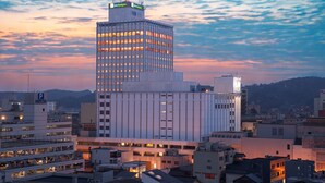 A modern high-rise building with multiple floors, large windows, and a flat roof. - Holiday Inn ANA Kanazawa Sky by IHG (Kanazawa)
