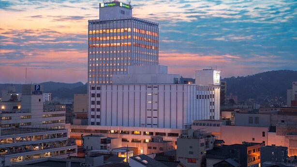 A modern high-rise building with multiple floors, large windows, and a flat roof. - Holiday Inn ANA Kanazawa Sky by IHG (Kanazawa)