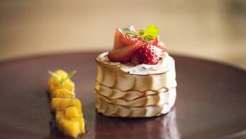 A dessert on a dark plate with a blurred background.