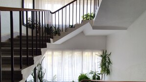 A multi-level staircase with black railings and potted plants at the bottom. - Pension Jana - Domov Mládeže (Prague)