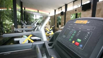 A gym with exercise equipment and a control panel.