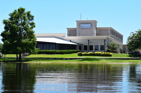 A modern building with a sign reading "BridgePoint" in front of a body of water.