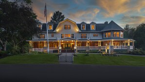 A large, two-story house with a prominent front porch, multiple windows, and a flagpole. - The Inn at Thorn Hill & Spa (Jackson)