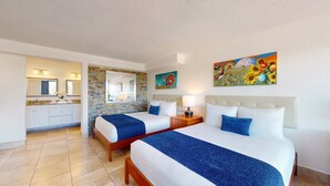 A hotel room with two beds, a bathroom, and a dining area. - Park Royal Orlando managed by Accor (Kissimmee)