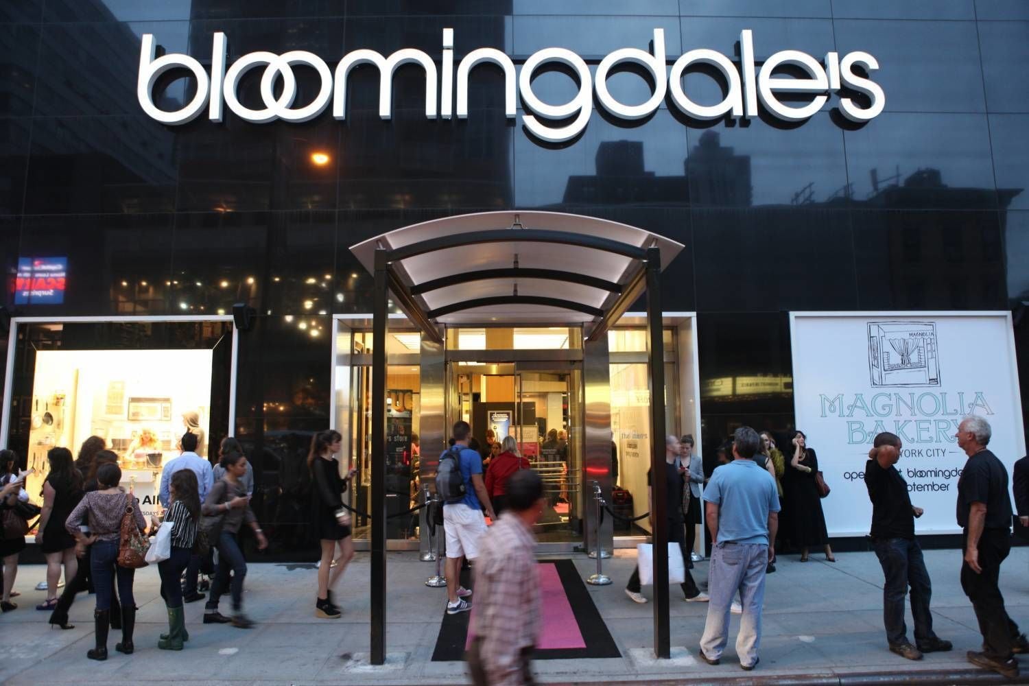A building with a glass facade and the name "bloomingdales" prominently displayed.