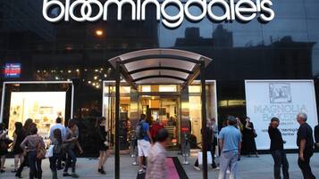 A building with a glass facade and the name "bloomingdales" prominently displayed.