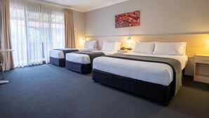 A hotel room with two beds, a desk, and a large window with curtains. - Maclin Lodge Motel (Campbelltown)