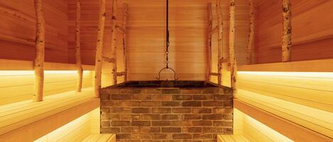 A sauna with wooden benches and a brick sauna room.