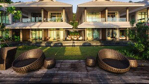A symmetrical building with a central courtyard, featuring outdoor seating and a well-maintained lawn. - Na Tara Resort (Ko Chang)