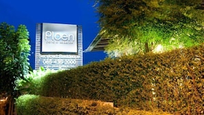 A night-time view of a hotel sign with the name 'Plen' and a website URL. - Ploen Pattaya Residence by Tolani (Pattaya)