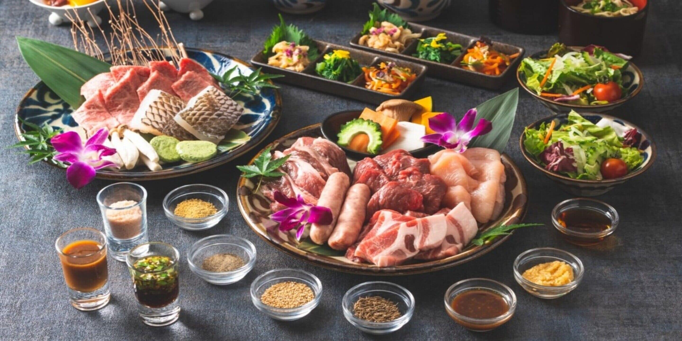 A variety of dishes including meats, vegetables, and condiments arranged on plates and bowls.