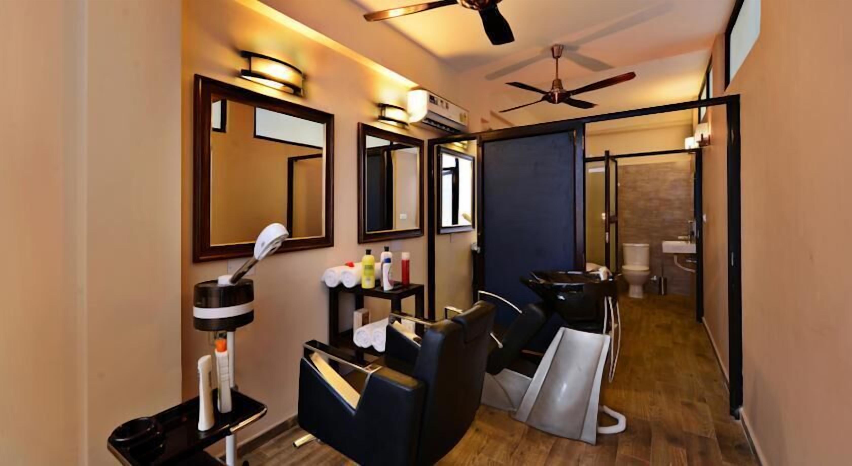 A modern bathroom with a vanity, mirrors, and a ceiling fan.