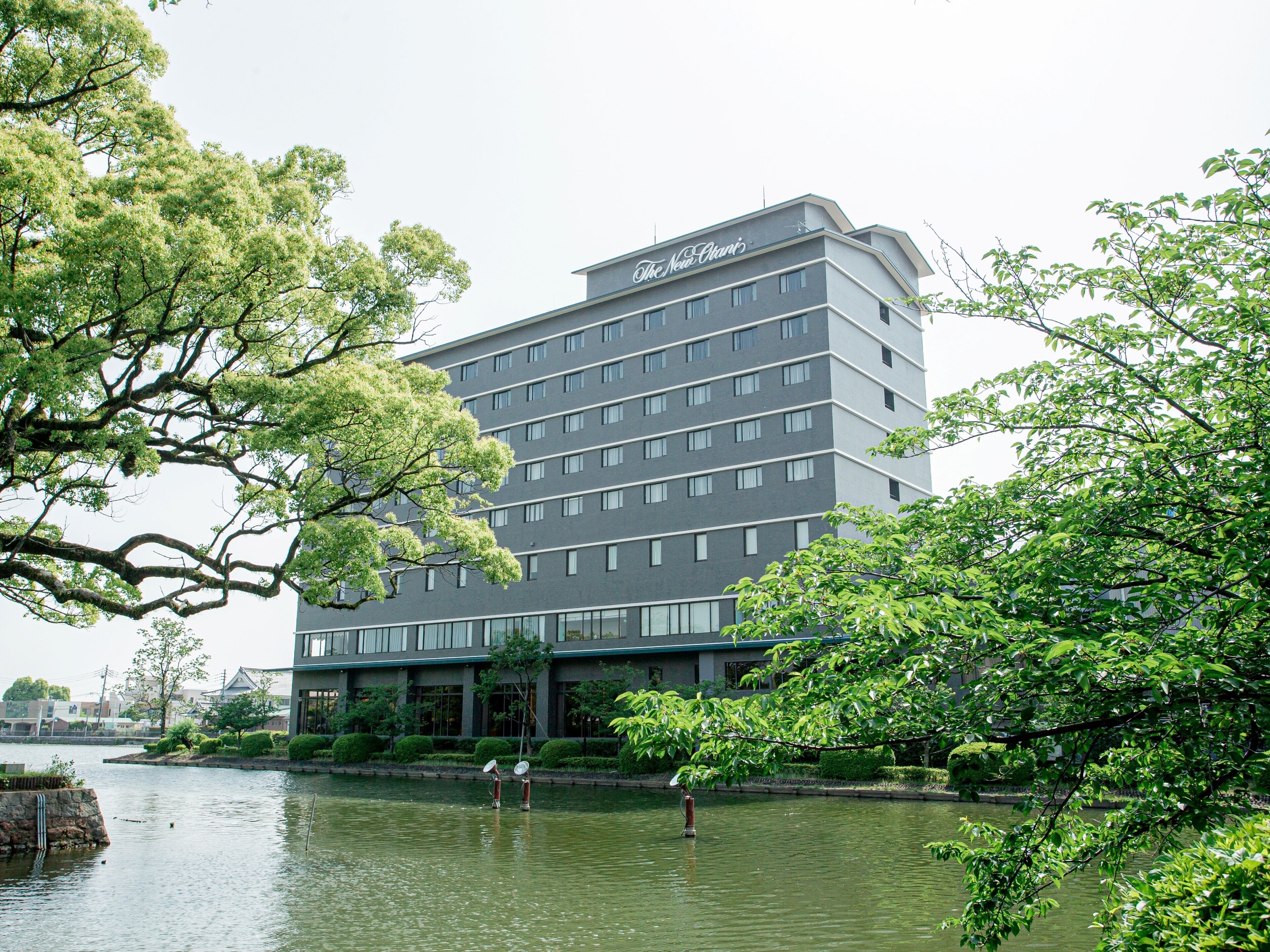 A multi-story hotel with a modern design, located near a body of water.