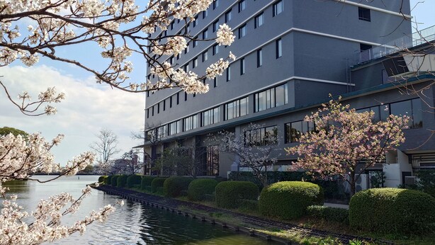 A modern building with a water feature in front.